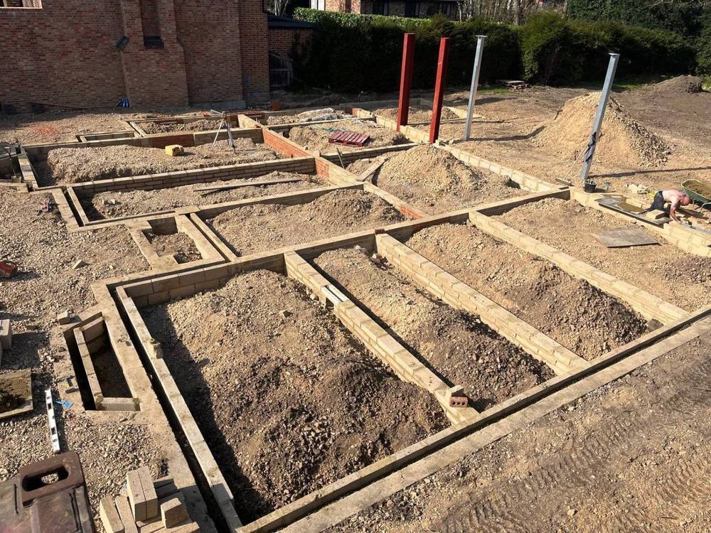 Brick and block substructure walls across a plot with steel columns set in