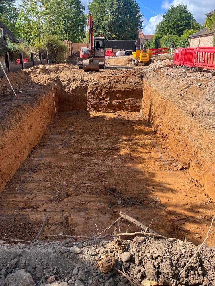 Deep excavation for a swimming pool with excavator and dumper