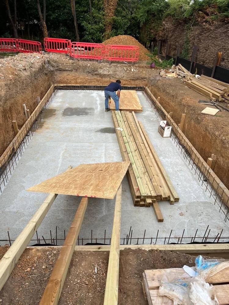 Reinforced base slab cast with starter bars standing around the edge